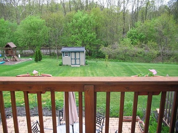 Very deep back yard with shed & tree line for privacy