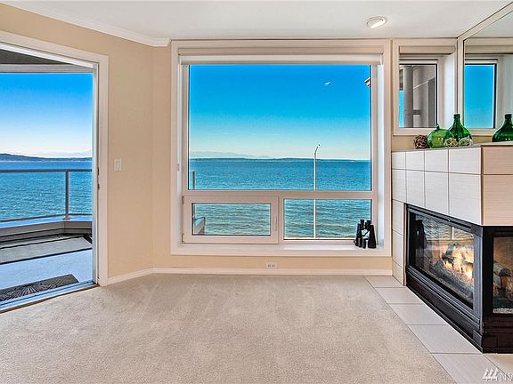 Living room with gas fireplace, gorgeous Puget Sound and mountain views!