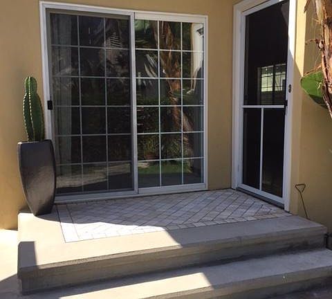 Back patio of home, with steps down into the garden