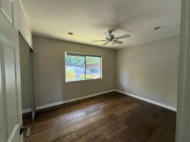 Another bedroom with a lovely view of the backyard overseeing the bocce court and the patio.