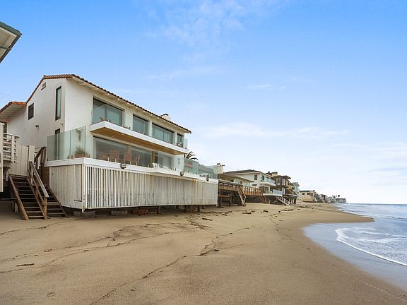 Step from the expansive beachfront deck straight onto the pristine sands, making it effortless to indulge in the sun and surf at any moment.