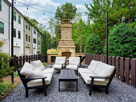 Unwind in the private courtyard featuring a cozy outdoor fireplace _ the perfect setting for morning coffee, reading a book, or simply enjoying a quiet night under the stars.