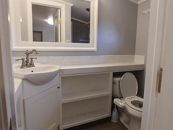 Quaint bathroom , with large mirror and bidet too!