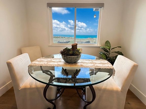 Enjoy meals with this breathtaking ocean view from elegant glass dining table.
