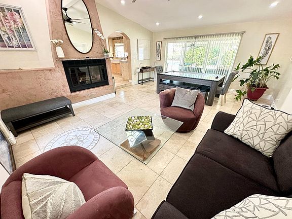 Living Room - dining table has removable top that becomes air hockey table and table tennis (shown as air hockey table).