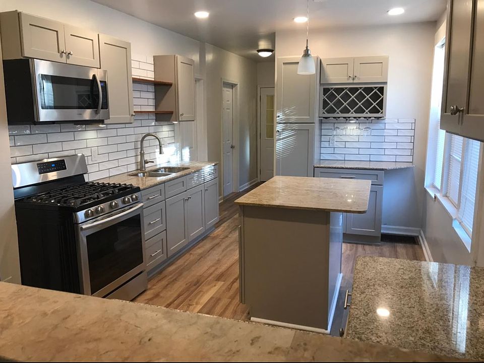 Open concept kitchen with eat-in island, granite countertops, wine bar, coffee bar, brand new appliances.