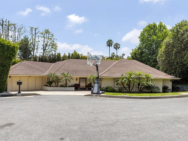 Full facade view showcases this single-story Beverly Hills luxury rental with mature palm landscaping at 1094 Garden Lane, 90210.