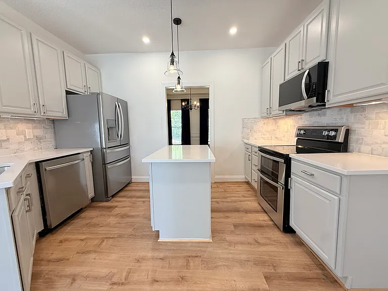 Chefs kitchen with state of the art appliances, Pendant lighting, island, tile backsplash, under cabinet lighting & so much more!