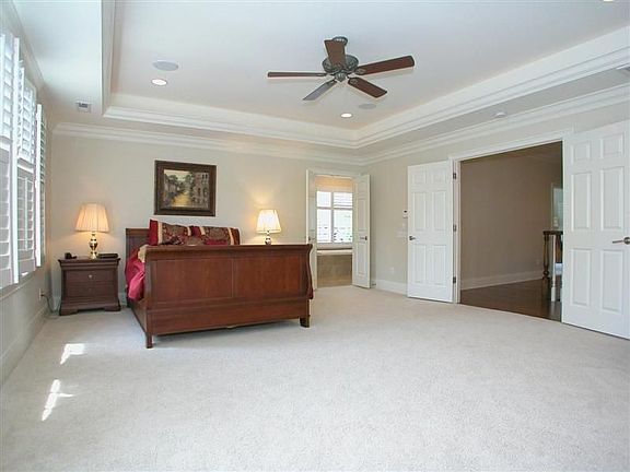 Huge Master suite with double doors, two custom walk-in closets & trey ceiling