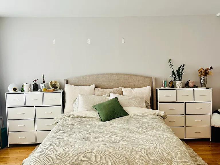 Queen size bed with storage bedside tables on both sides