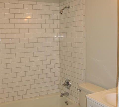Full bath with shower/tub in hallway between the two bedrooms