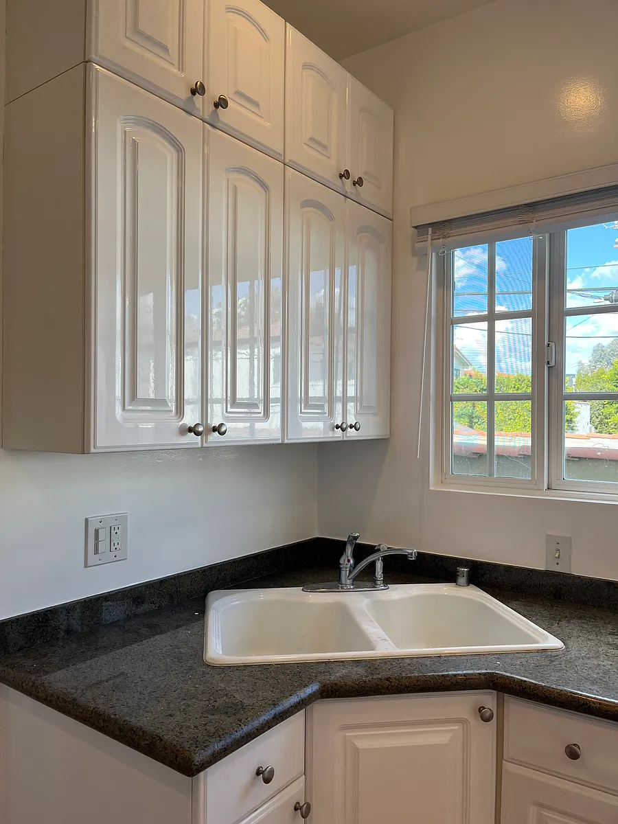 KITCHEN IS BRIGHT AND HAS NEW DESIGNER CABINETS AND GRANITE COUNTERTOPS - 9549 W Olympic Blvd