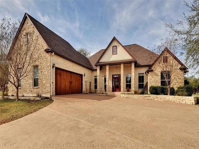 Gorgeous stone with attractive wood garage door