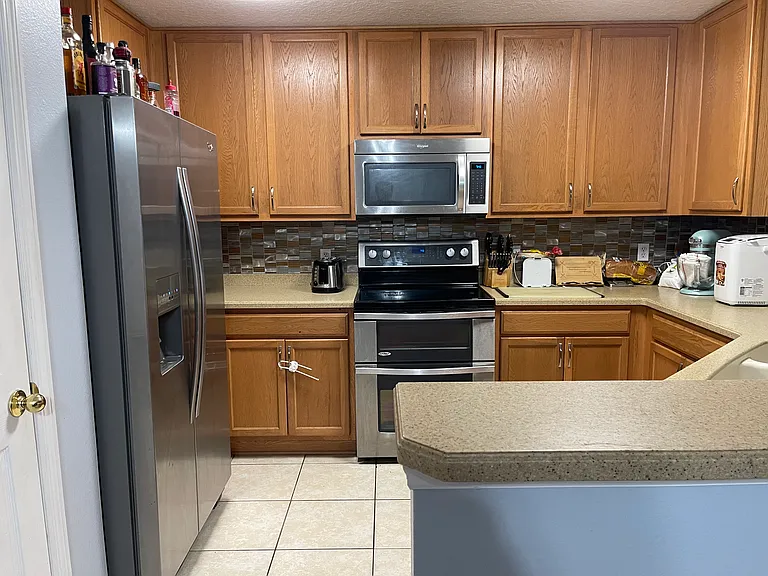 Entrance to kitchen area between bar (right) and pantry (left)