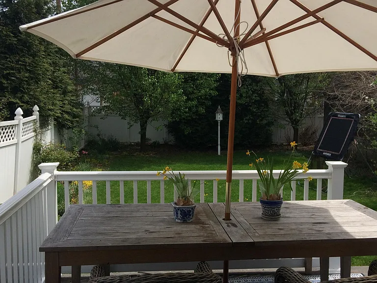 Fenced in double lot back yard with deck