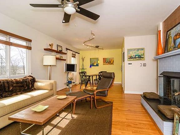 Living room area with fireplace (showing furnished for reference only)