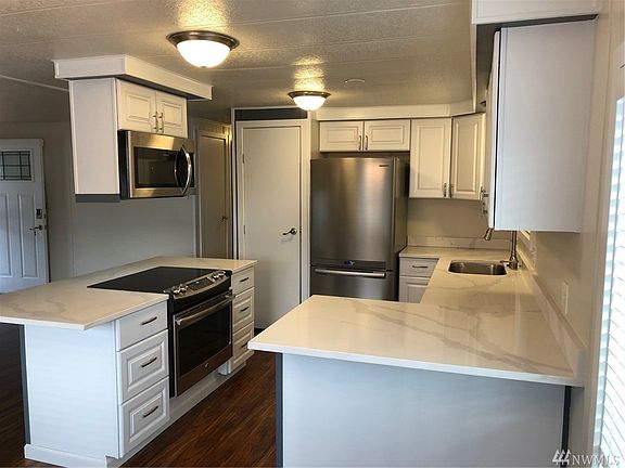 two Breakfast bars  - means ample room for informal entertaining. Plenty of cabinet space, including a food pantry pictured. 