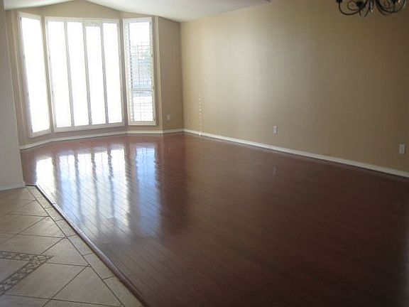 Formal Living & Dining with Hard Wood Floors & Plantation Shutters.