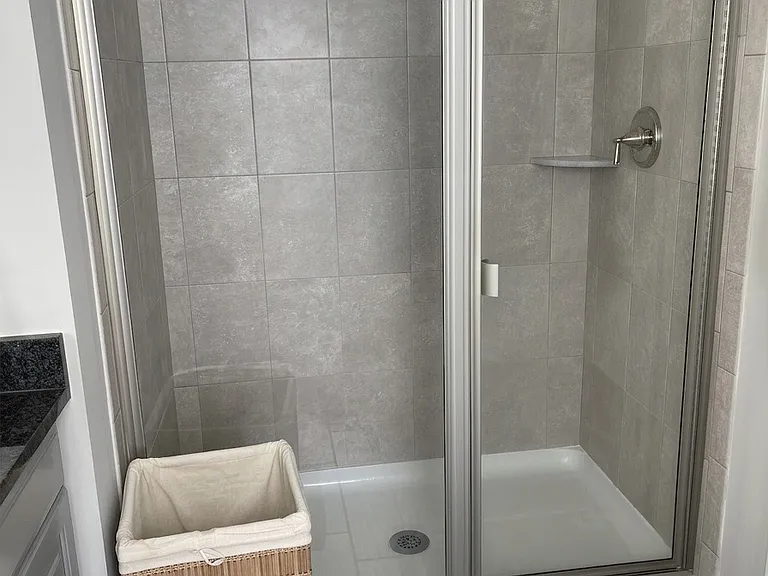 Primary suite Full BA standing shower with seating area