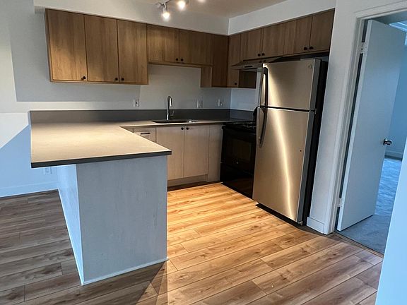 Unit 17 Kitchen - New cabinets, quartz countertops and a new electric stove, and new stainless refrigerator.