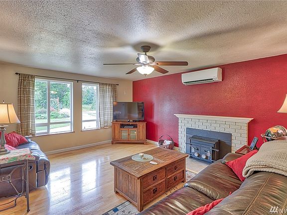 Living room with hardwood floor, fireplace and ductless Heat/AC