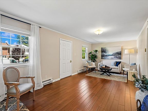 Front living room has wood flooring and two windows for great light.