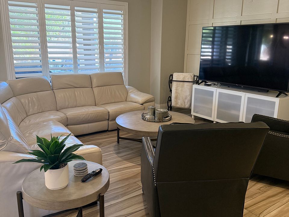 Cozy living room with leather sectional and reclining chairs.