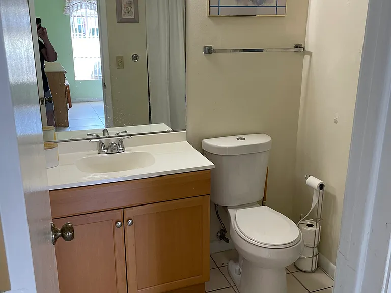 HALF BATH FOR COMPANY HAS A SPACE-SAVING SLIDING POCKET DOOR