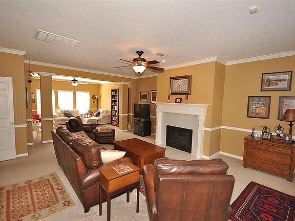 The entry continues through a large living room that connects to an extended sitting area.
