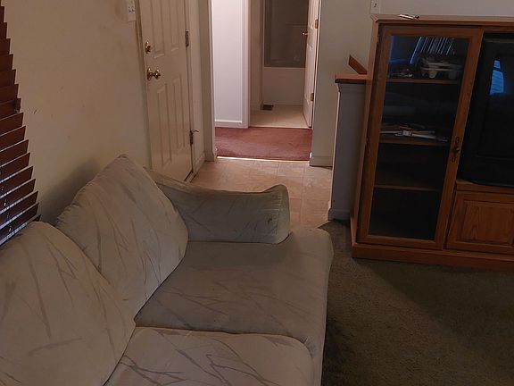 View of front door, hallway, bathroom from living room. Both bedrooms are off this hallway