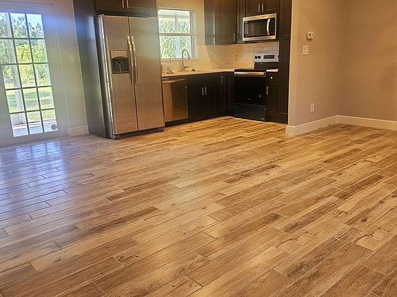 The kitchen has been completely upgraded with brand new soft-close cabinets, a sleek modern white backsplash, and stunning quartz countertops. It also features all-new stainless steel appliances, a reverse osmosis system, and a garbage disposal.