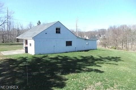 Side view of 3+ car garage.  Has steps to floored 2nd floor and lean to on rear was originally a 3 stall barn for horses.