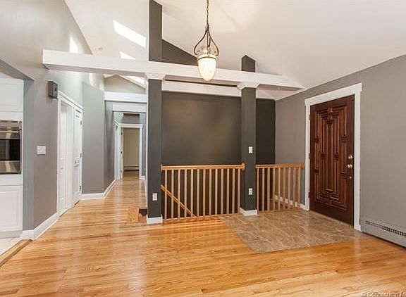 Custom mahogany door and travertine floor provide perfect entrance.