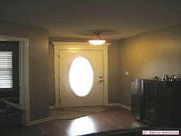 beautiful wood floors can be seen from front entry, door to office on left