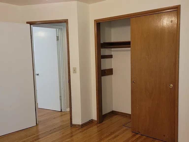 bedroom #2 in the front of house, window faces back yard, ceiling fan, real hard wood floors