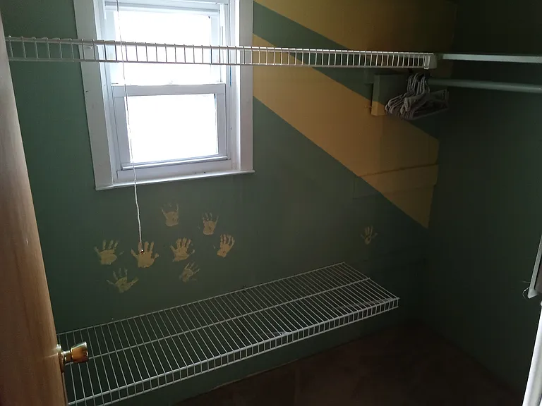 small walk in closet off larger bedroom downstairs. also contains new breaker box.