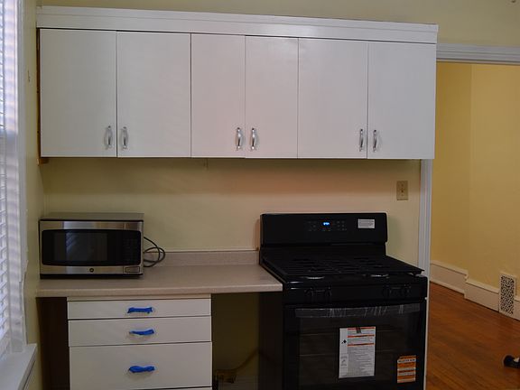 West view of the Kitchen. New gas oven and Microwave. Note there is lots of shelves