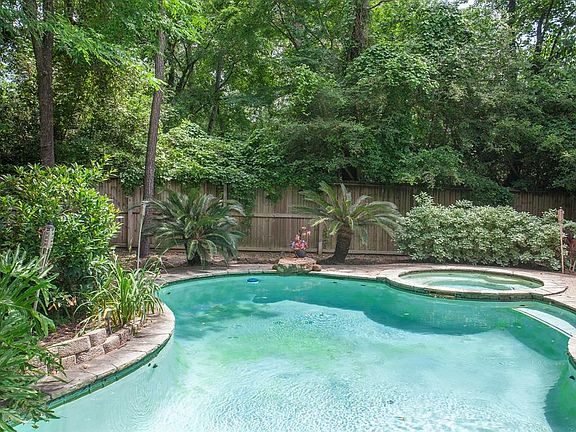 Towering trees and mature landscaping surround the refreshing pool and spa...