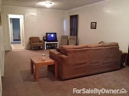 Living room from front door : Living room leads to hall with bedroom and bathroom.
