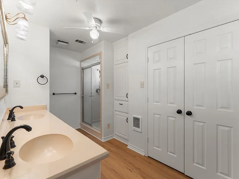 Dual sink vanity with matte black fixtures and light-toned countertop