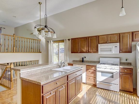 Open kitchen layout with hard wood floors.