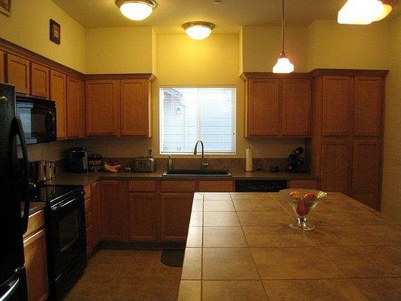 Large Tile Counter Tops. Pantry space and very functional.