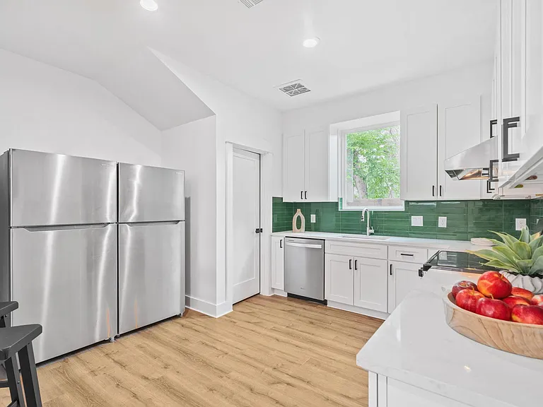 Updated kitchen with stainless steel appliances, ample cabinetry, and a large sink under a window for everyday prep.