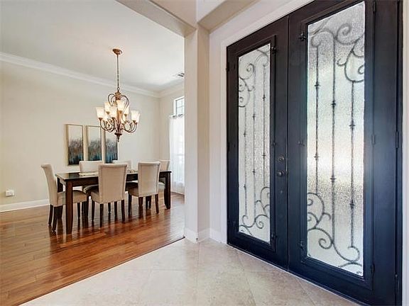 Double front doors open to the grand foyer.