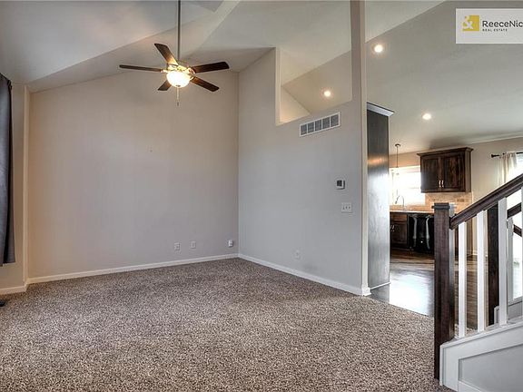 Great room with vaulted ceiling opens to eating area