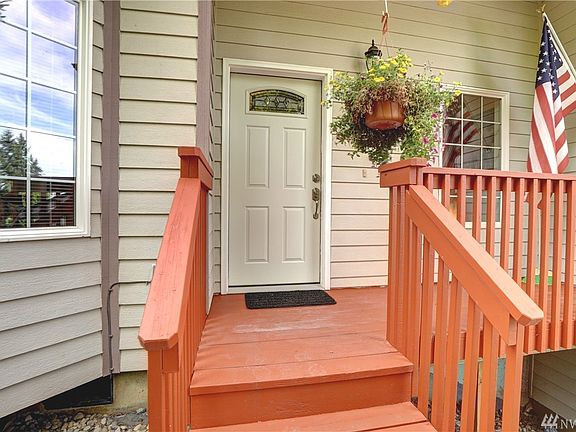 A covered front entrance has room for outdoor sitting area. 