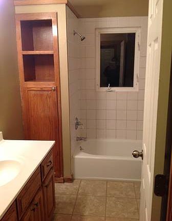 Full bath on main floor with tile surround.