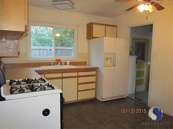 Cute county kitchen has lots of counter space and is ready for your decorator touches.