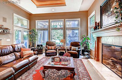 Living room wall of windows facing golf course