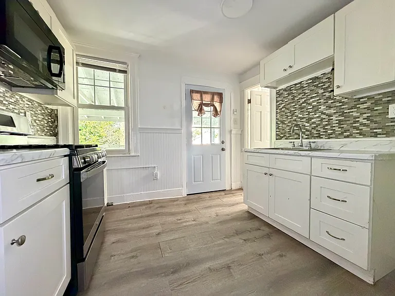 Kitchen Area w/ door to Bathroom